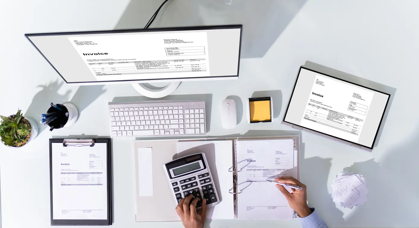 Accountants Farnham. An image of an accountants desk, containing a laptop, tablet, calculator, diary and check list.