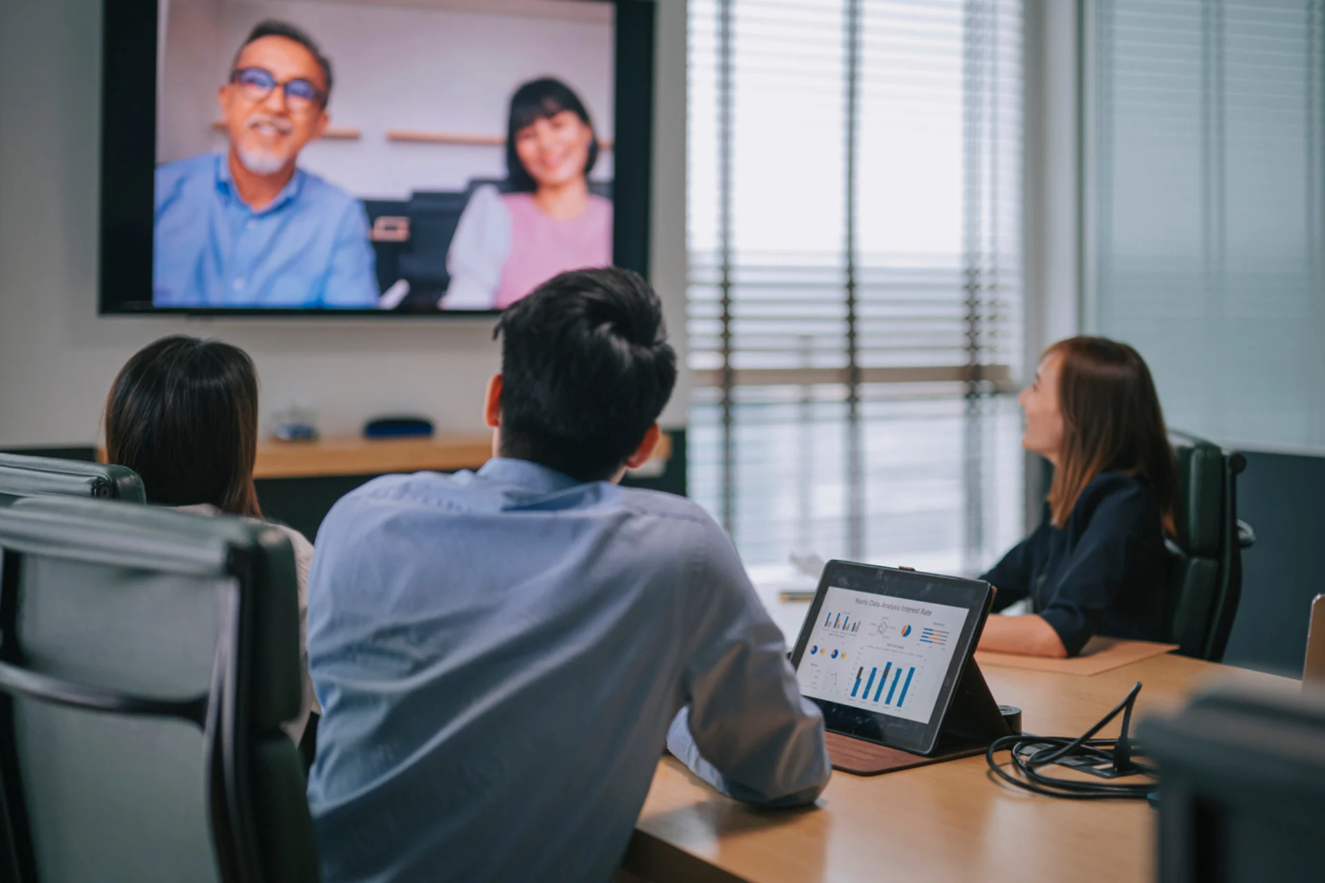 An image of online Accountants holding a virtual meeting with two business owner clients via Zoom